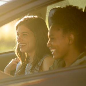 two women in a car driving