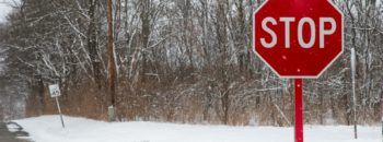 icy road with a red stop sign