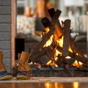 fire in fireplace with boots on hearth