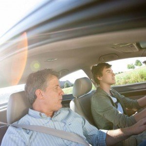 Teen and dad driving