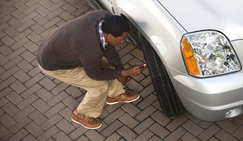 Man checking tire pressure