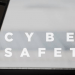 a laptop with text 'cyber safety'