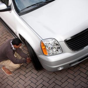 man fixing car tire