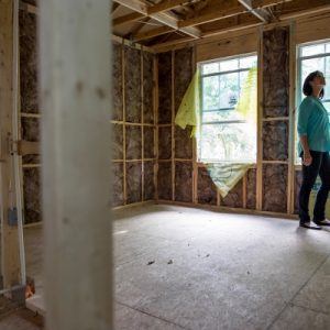 Woman standing in a newly constructed home