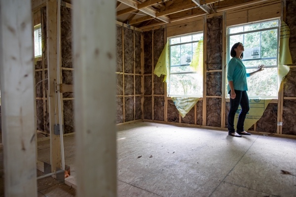Woman standing in a newly constructed home