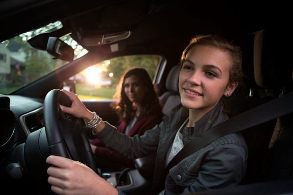 teenage girl driving car