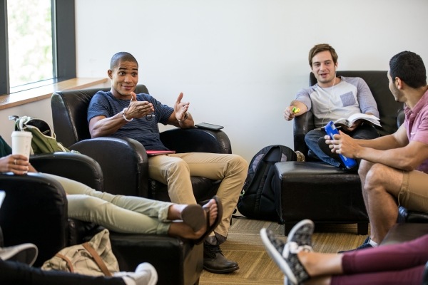 Men sitting in leather armchairs