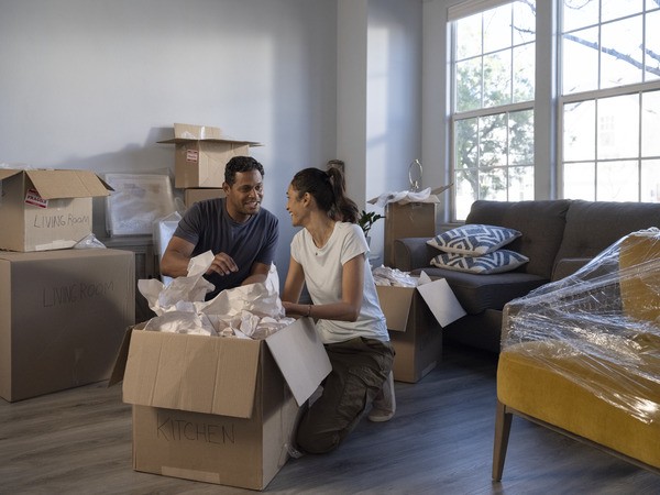 Couple packing moving boxes
