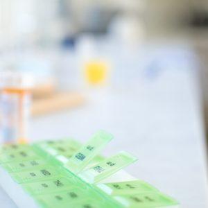 medicine bottles next to pill organizer