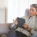 man looking at ipad on couch