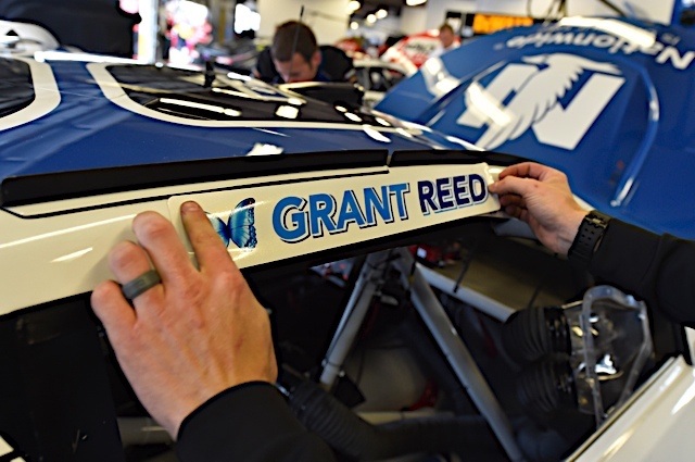 Grant Reed sticker being placed on car
