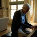 elderly man playing a piano