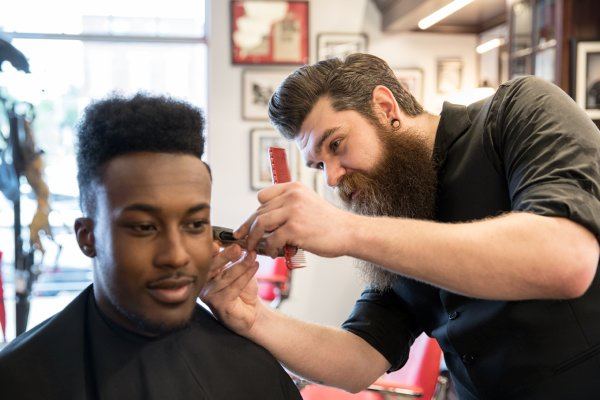 Barber cutting a customer's hair