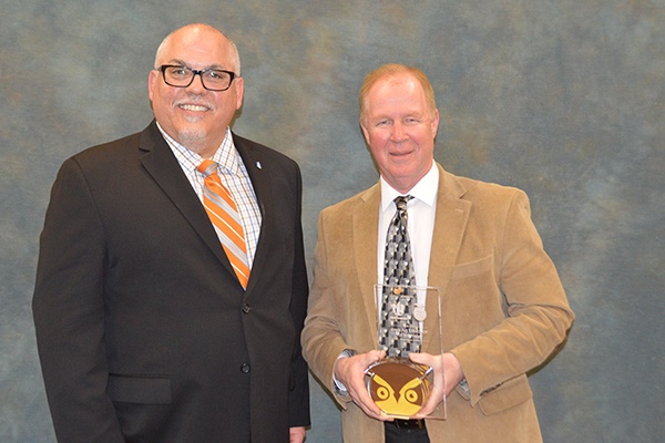 Two men receiving an award