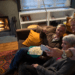 elderly couple with middle aged son taking a selfie on a sofa