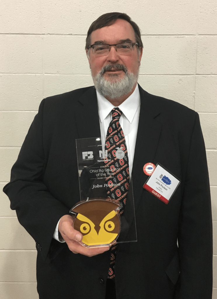 John Poulson holding golden owl trophy