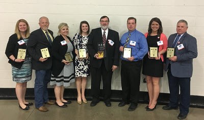 Award winners holding plaques