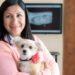 Woman holding dog in doctor’s office