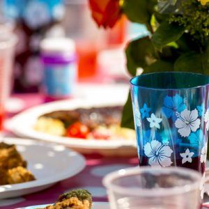 A party table with food, drink, flowers, and decorations
