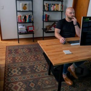 man working at desk in home office