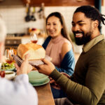 A happy family having a meal together at the table.