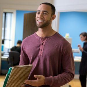 Man holding paperwork in an office
