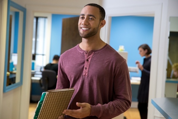 Man holding paperwork in an office