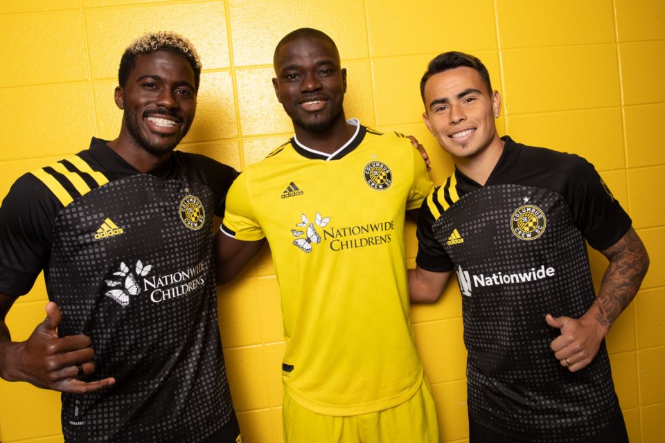 three columbus crew soccer players smiling