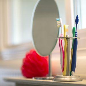 toothbrushes and a mirror in a bathroom