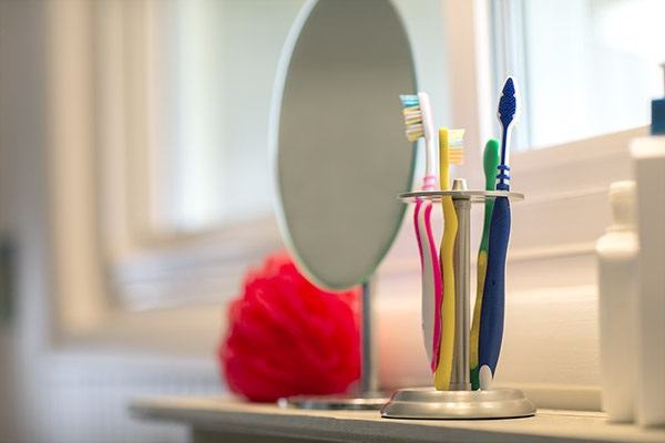 toothbrushes and a mirror in a bathroom