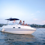 Three people enjoying recreational boating.