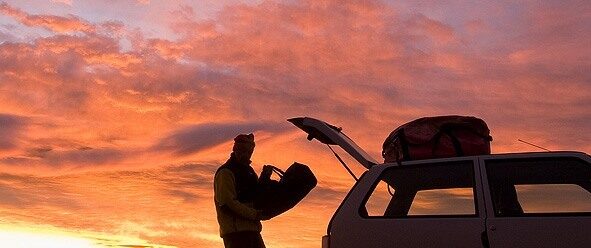 a person packing items in the trunk of their car