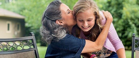 an mom kissing a child