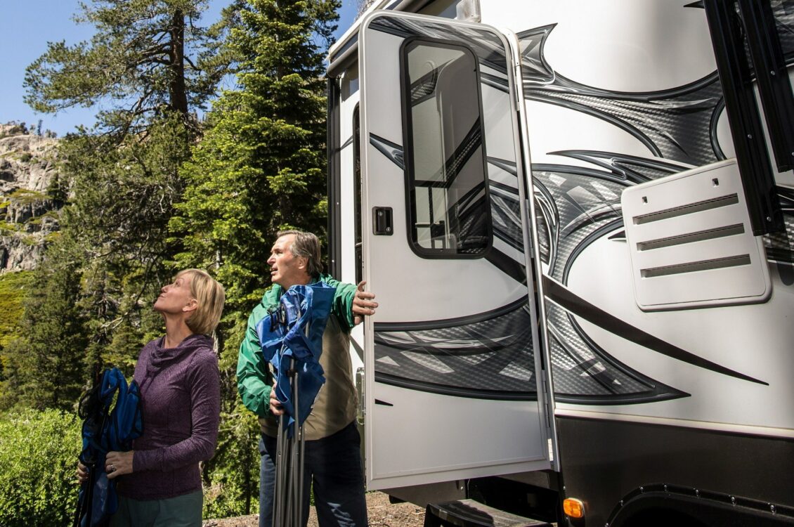 a couple getting out of an RV