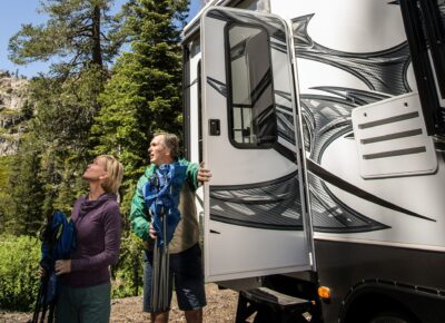 a couple getting out of an RV