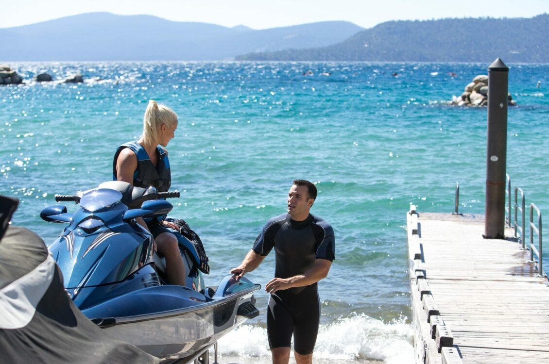 man and woman by jet ski