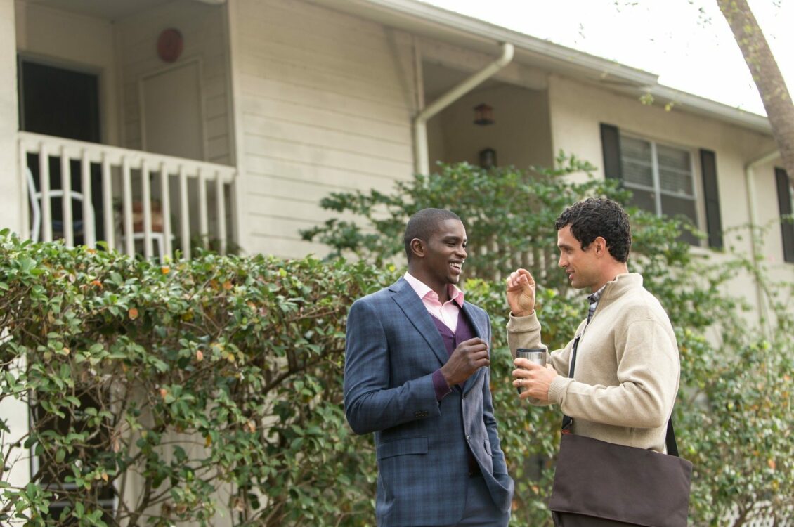 men outside a house