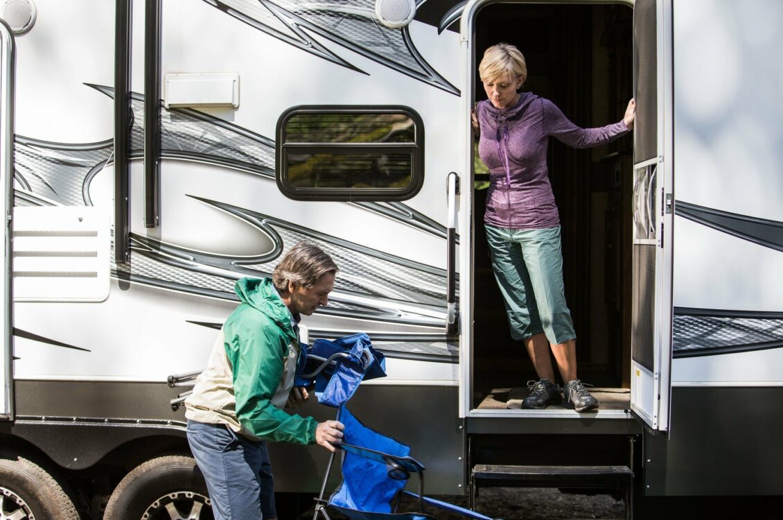 a woman opening a door to an RV