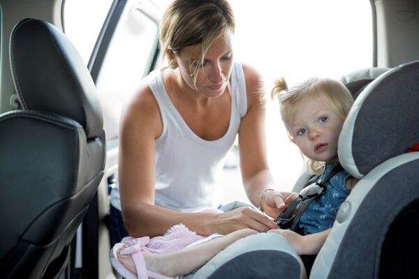 woman with baby in car seat