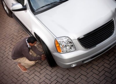 man fixing car tire