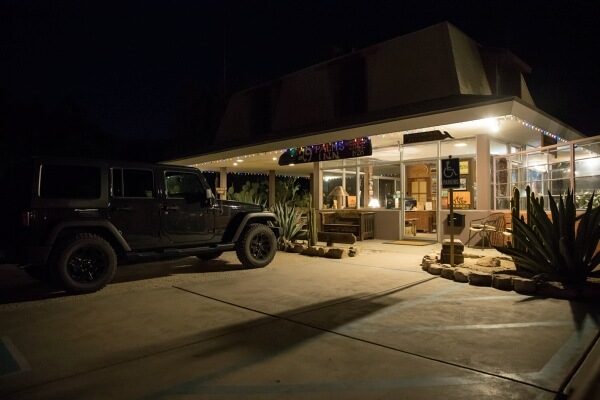 Black Jeep parked in driveway at night