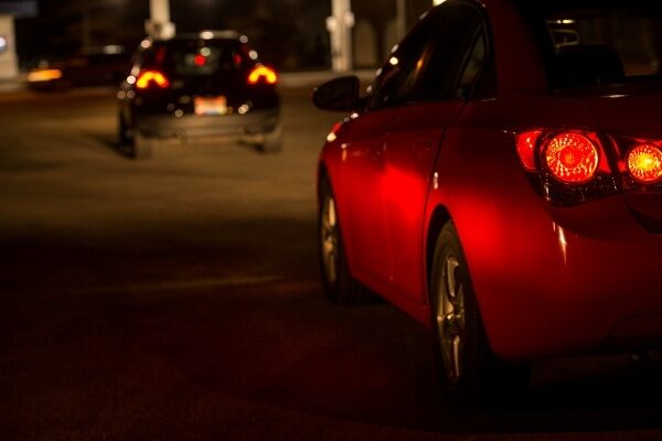 Driver-side brake light on a red 2-door car.