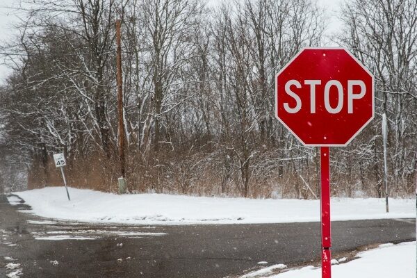 icy road with a red stop sign