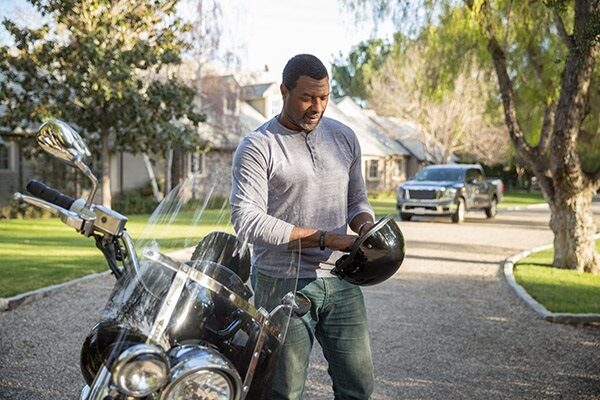 a man putting on a motorcycle helmet