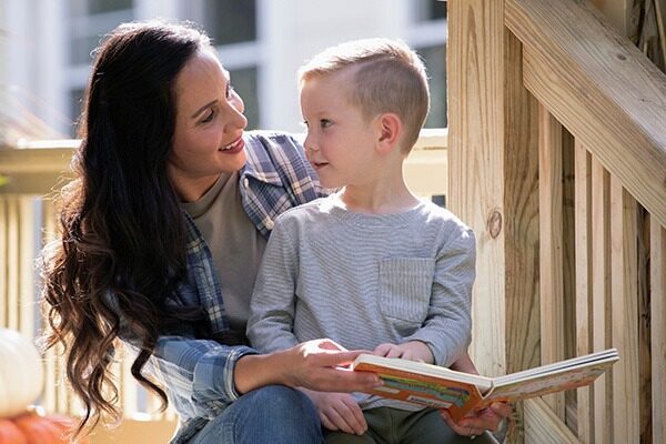 mother reading a book to her son