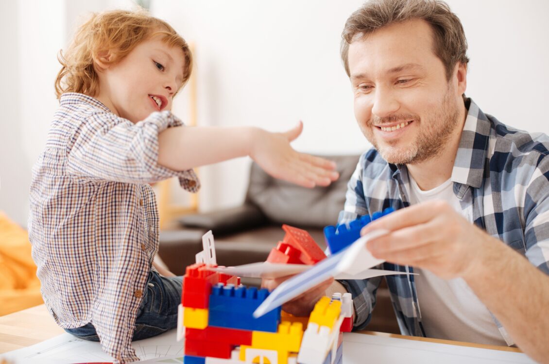 man and son playing with legos