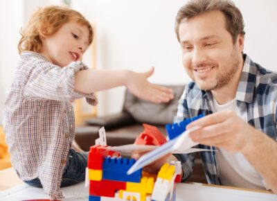 man and son playing with legos