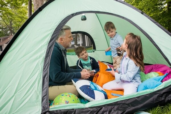 father in a tent with his kids