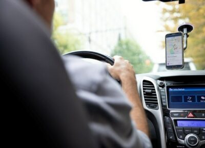 man driving car with dashboard in view