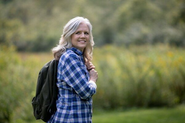 a happy woman hiking